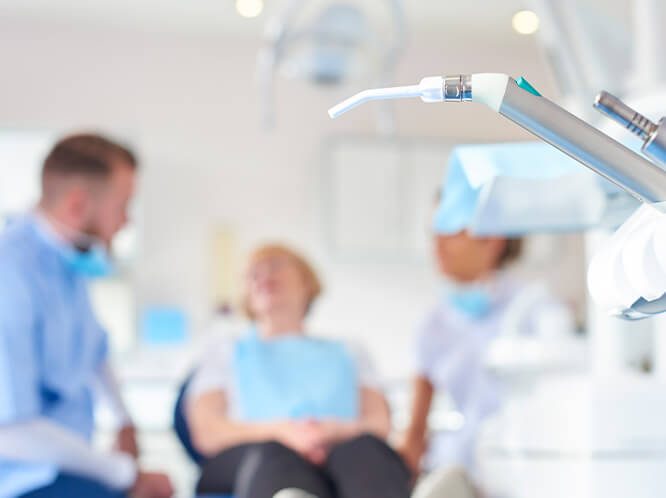 Dentist and patient talking dental implants | Jersey